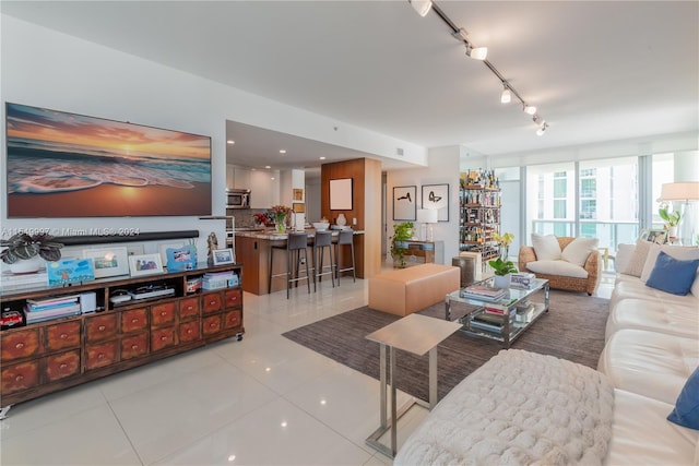 living room with light tile floors and rail lighting