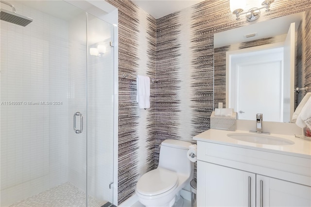 bathroom with oversized vanity, toilet, and a shower with shower door