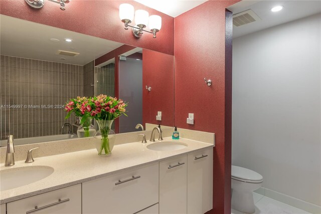 bathroom featuring double sink vanity, toilet, and tile floors