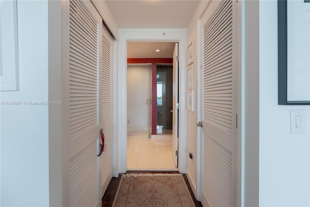 corridor with dark tile flooring