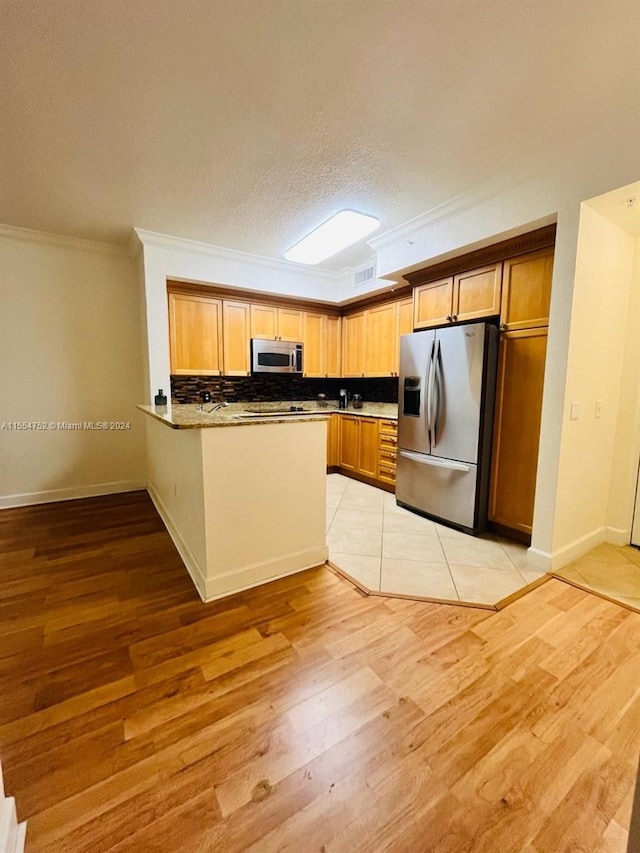 kitchen featuring backsplash, stainless steel appliances, light tile floors, and crown molding