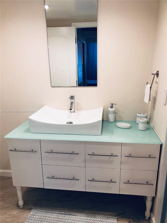 bathroom featuring tile flooring and vanity