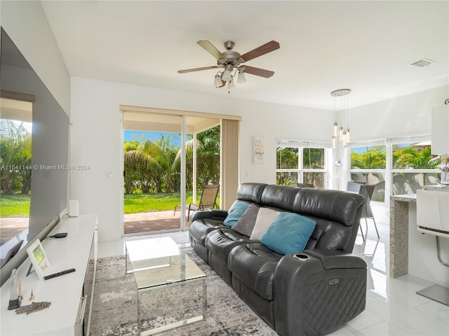 living room with ceiling fan, visible vents, and tile patterned floors