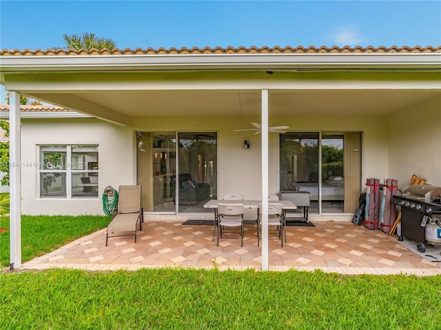 back of house featuring a ceiling fan, a patio, and stucco siding