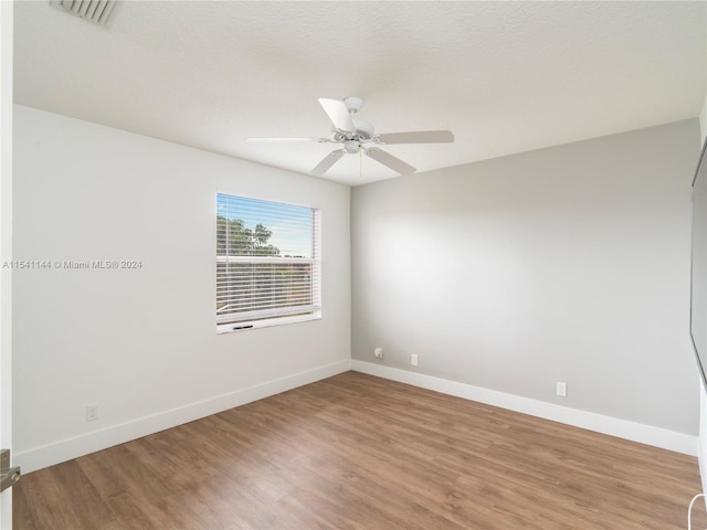 unfurnished room featuring visible vents, ceiling fan, baseboards, and wood finished floors