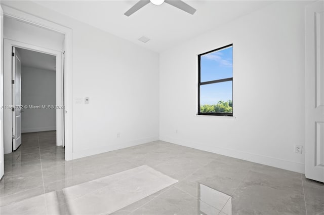 unfurnished room with baseboards and a ceiling fan