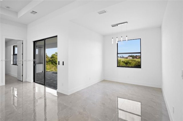 spare room featuring marble finish floor, visible vents, and baseboards