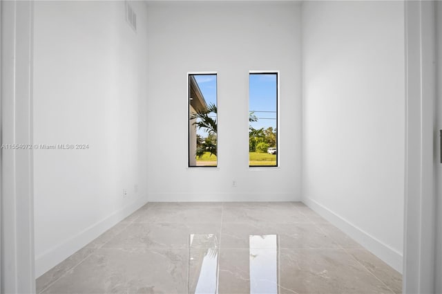 empty room featuring visible vents and baseboards