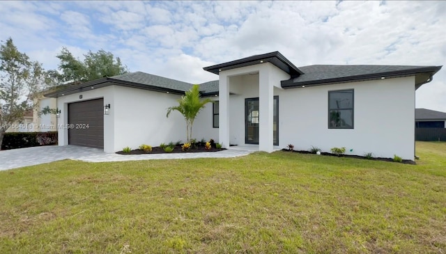 view of front facade with a front yard and a garage