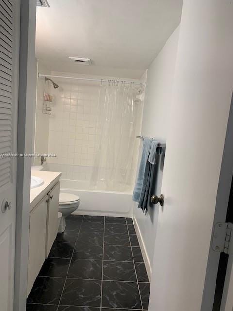 full bathroom with toilet, tile floors, tiled shower / bath combo, and vanity