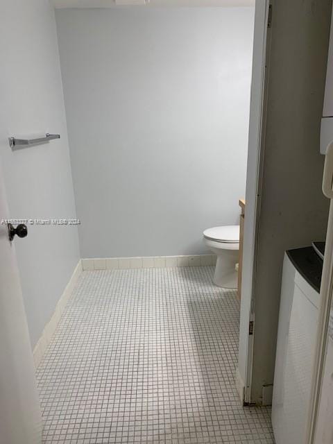 bathroom with toilet and tile flooring