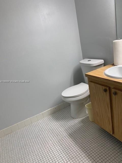 bathroom with vanity, tile flooring, and toilet