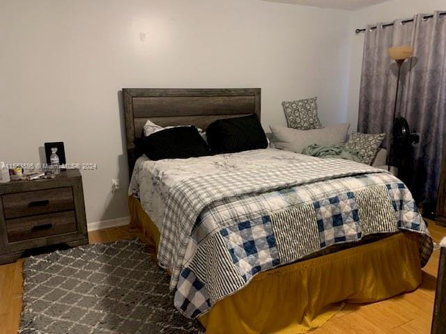 bedroom with hardwood / wood-style flooring