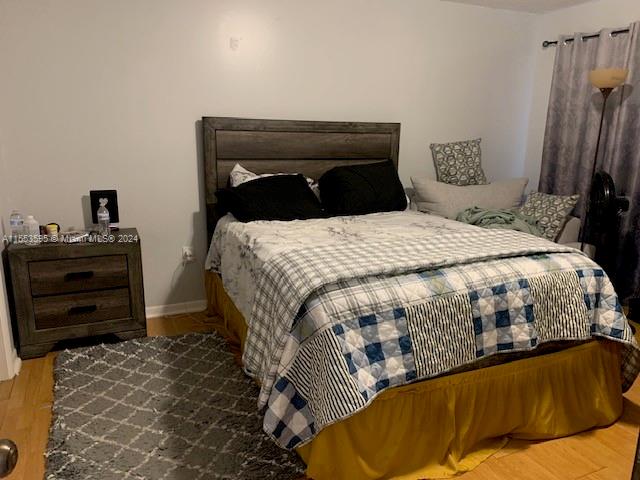 bedroom with hardwood / wood-style flooring