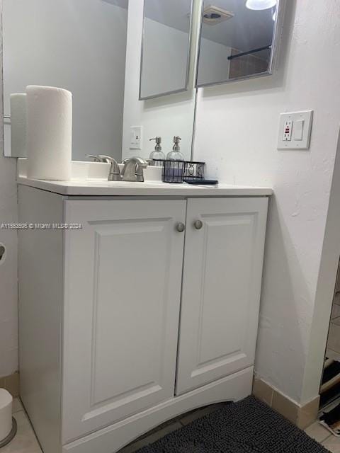 bathroom featuring tile floors, toilet, and vanity