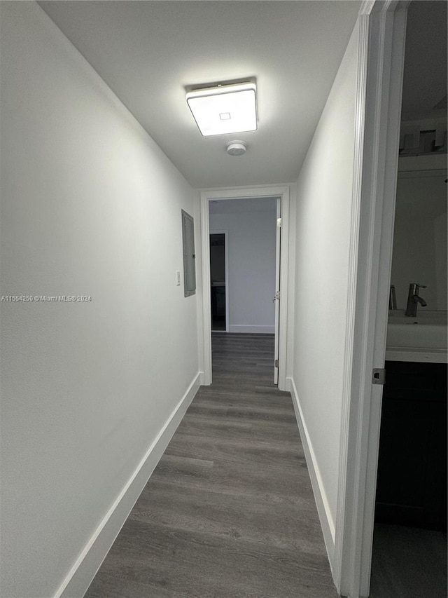 hallway with dark wood-type flooring and sink