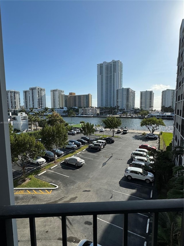 view of car parking with a water view