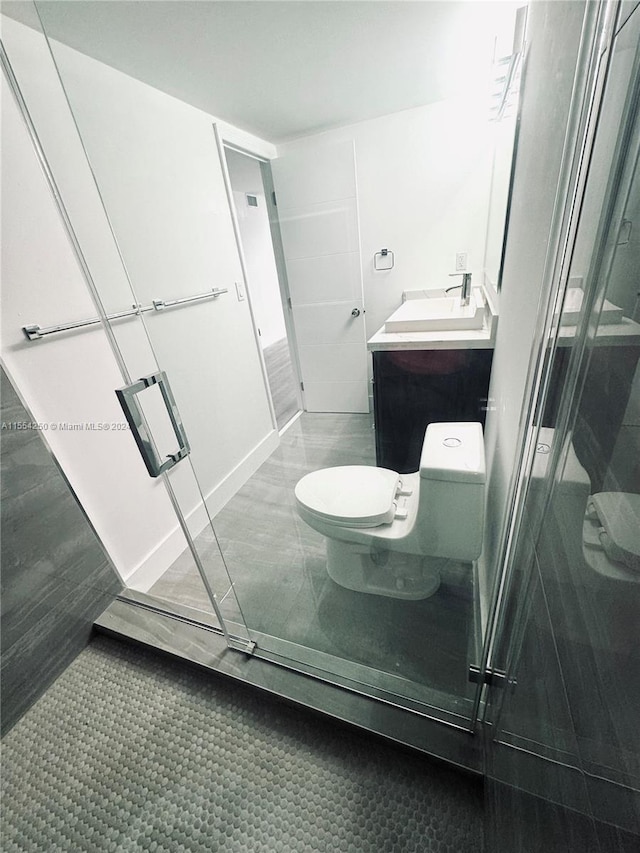 bathroom featuring toilet, tile flooring, and vanity