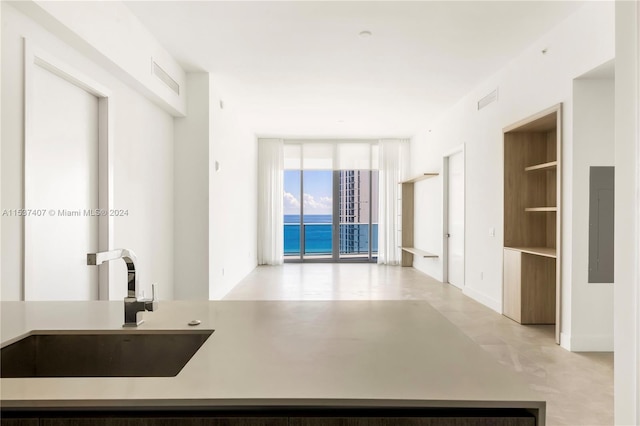 kitchen with electric panel, sink, and a water view