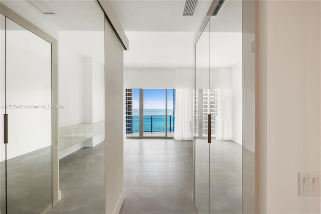 interior space featuring concrete flooring and a water view