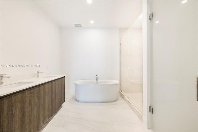 bathroom featuring vanity and separate shower and tub