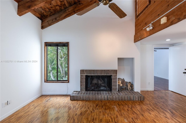 unfurnished living room featuring a fireplace, hardwood / wood-style flooring, ceiling fan, and high vaulted ceiling