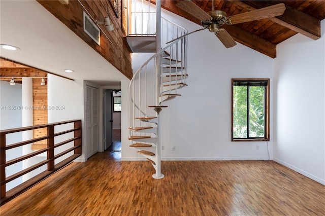 stairway with high vaulted ceiling, beamed ceiling, wood-type flooring, and wooden ceiling