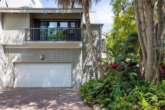 exterior space featuring a garage and a balcony