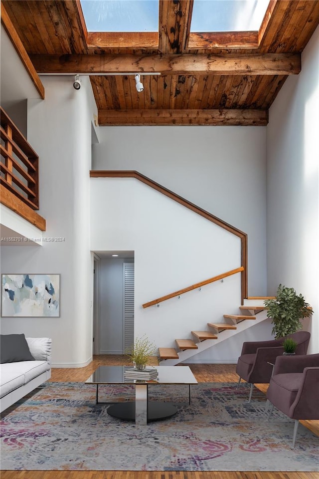 unfurnished living room featuring vaulted ceiling with beams and wood ceiling