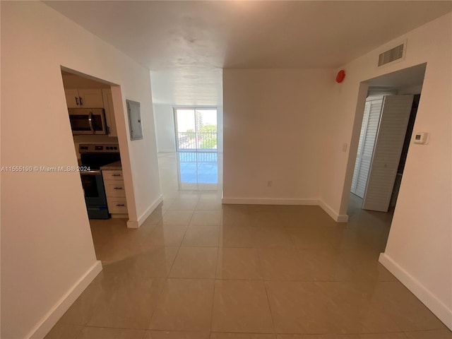 hall featuring light tile floors