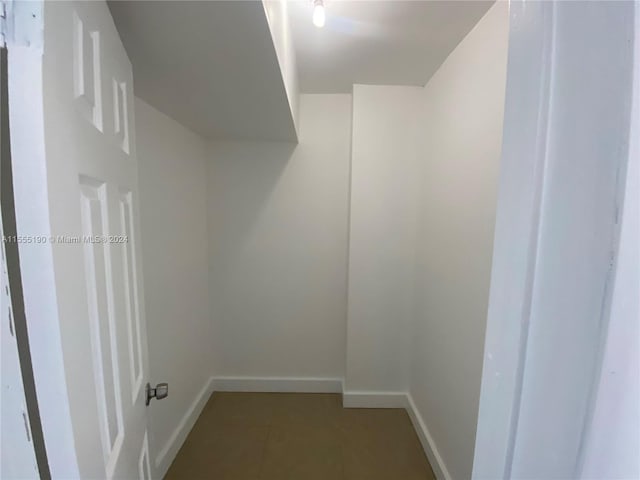 spacious closet featuring light tile floors