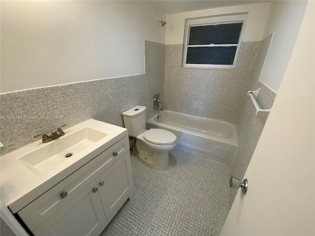 full bathroom with vanity, backsplash, tile floors, toilet, and washtub / shower combination