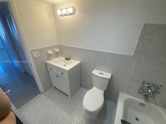 bathroom with vanity, tile walls, tile flooring, toilet, and tasteful backsplash