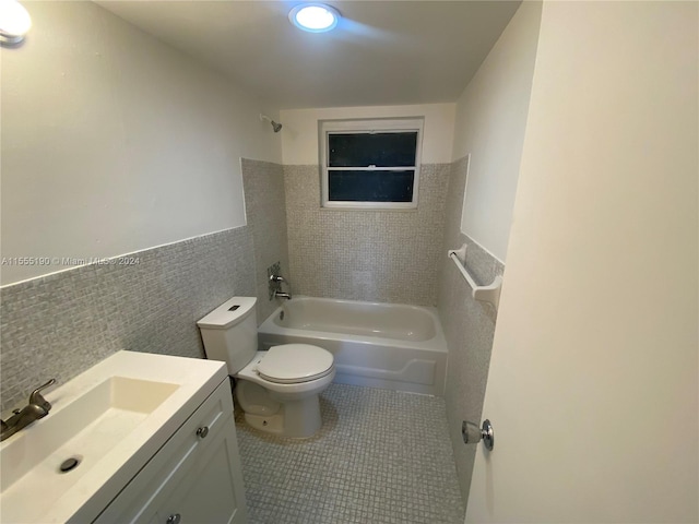 full bathroom with toilet, shower / bath combination, vanity, tile walls, and tile flooring