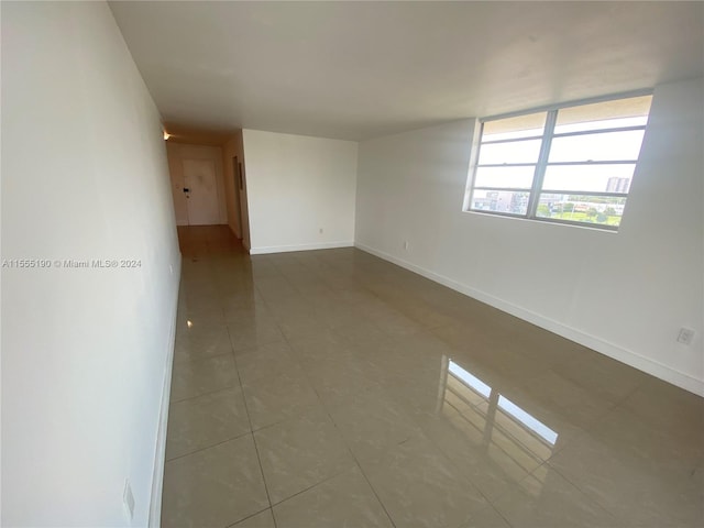 spare room featuring tile floors