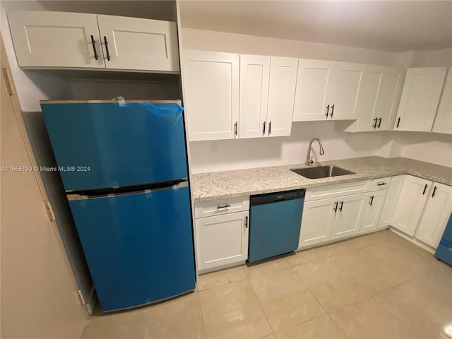 kitchen featuring light tile flooring, sink, white cabinets, dishwasher, and black fridge