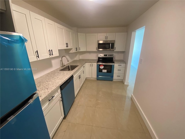 kitchen featuring sink, stainless steel appliances, light tile floors, white cabinets, and light stone counters