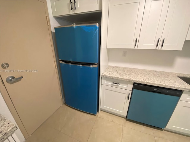 kitchen featuring white cabinets, dishwasher, and black fridge