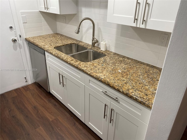 kitchen with dark stone counters, dark hardwood / wood-style floors, tasteful backsplash, white cabinets, and dishwasher