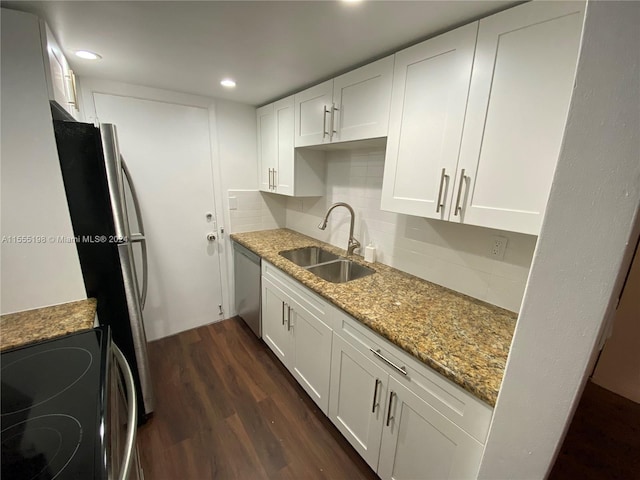 kitchen featuring white cabinetry, backsplash, dark hardwood / wood-style floors, appliances with stainless steel finishes, and sink