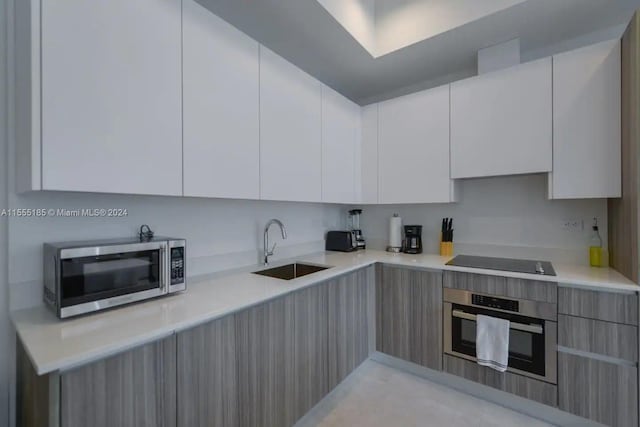 kitchen with white cabinetry, appliances with stainless steel finishes, and sink