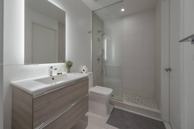 bathroom with vanity, tile floors, toilet, and tiled shower