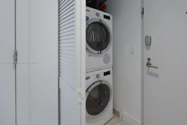 washroom featuring stacked washer / dryer