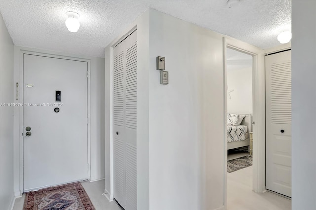 corridor featuring a textured ceiling