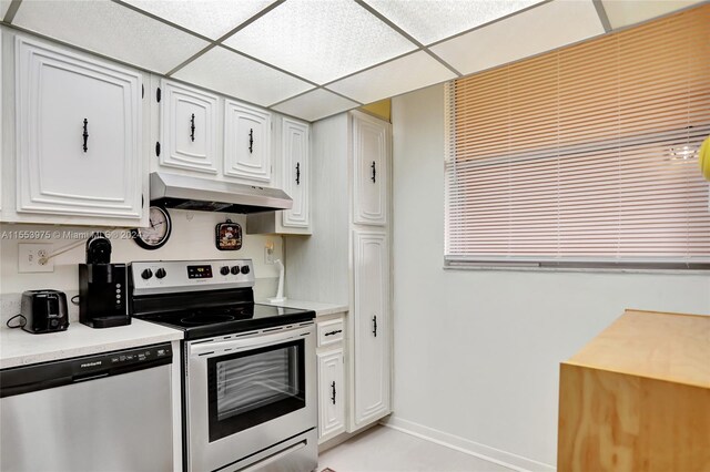 kitchen with white cabinets, range with electric cooktop, stainless steel dishwasher, and a drop ceiling