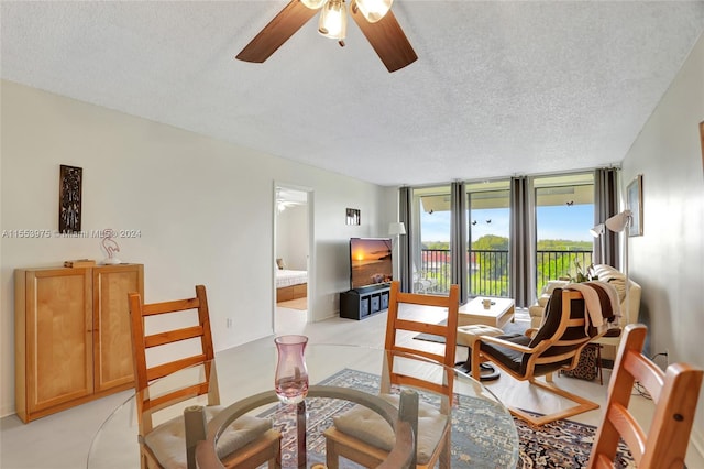 dining area featuring floor to ceiling windows, ceiling fan, and a textured ceiling