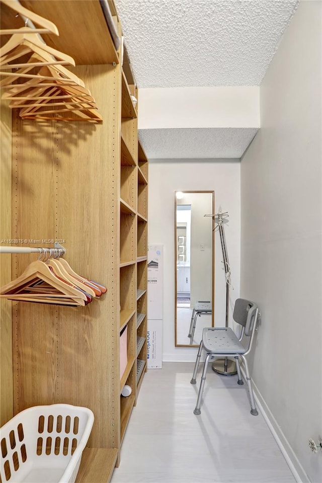 spacious closet featuring light hardwood / wood-style floors