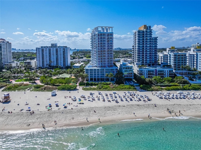 bird's eye view featuring a water view and a view of the beach