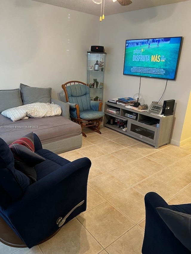 living room featuring light tile floors and ceiling fan