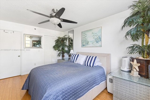 bedroom with light hardwood / wood-style floors and ceiling fan